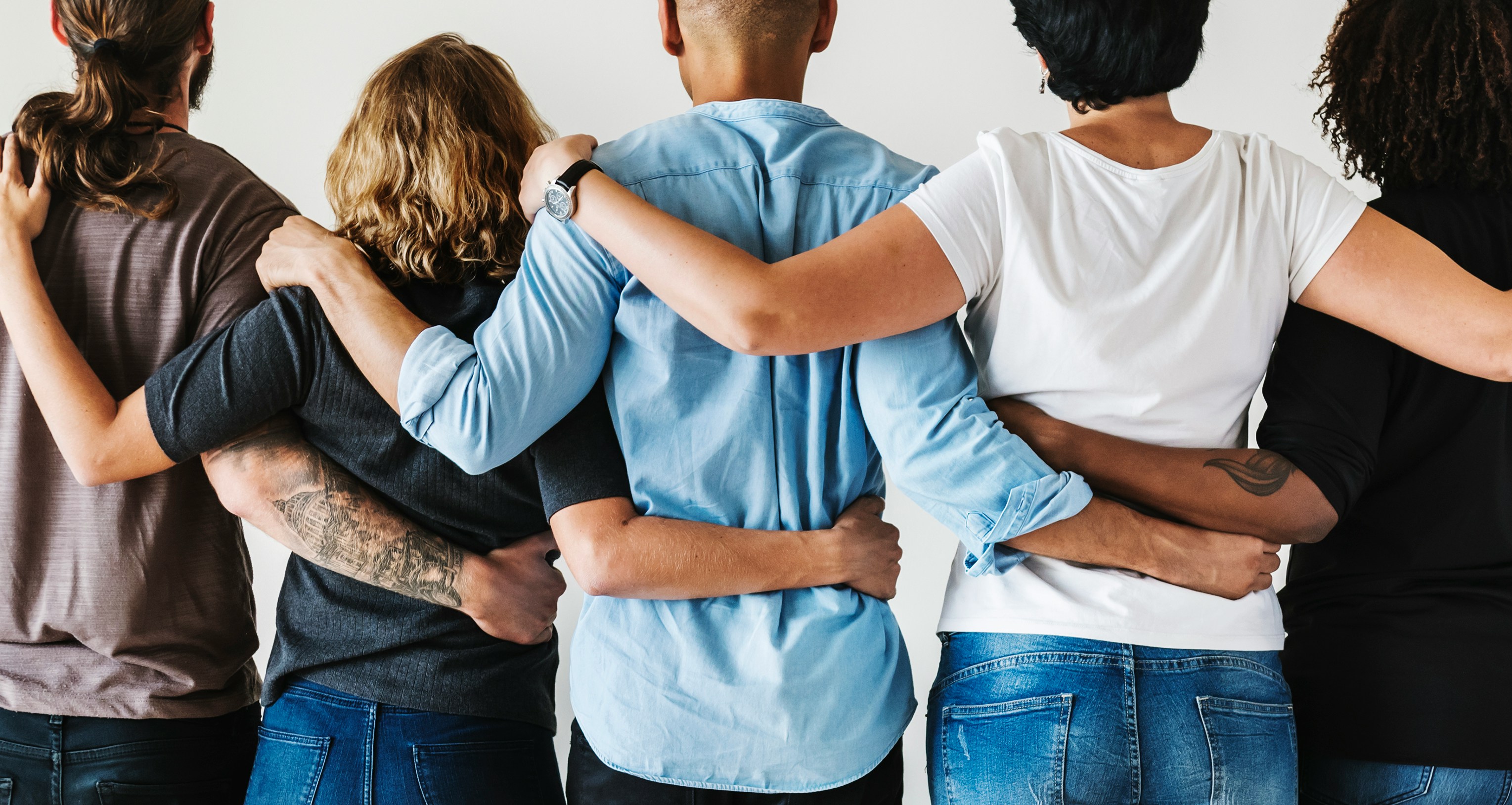 A close-knit group standing together, arm in arm